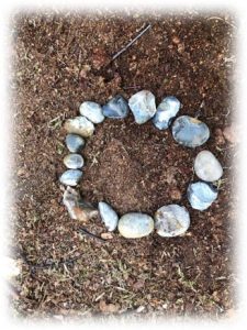 A circle made from stones, lying flat on the ground outdoors